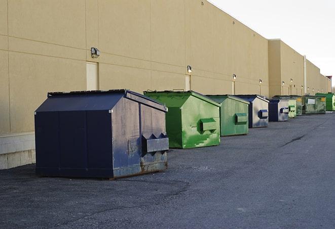 a group of construction workers taking a break near a dumpster in Clayton